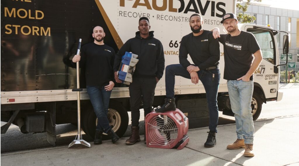 Paul Davis Restoration team standing in front of service truck with equipment ready for emergency restoration services in Mid-Hudson Valley.